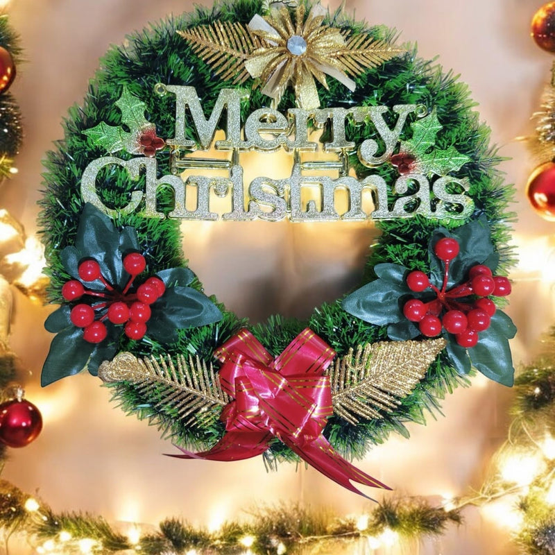 Go Hooked green Christmas wreath with "Merry Christmas" glitter text, red berries, gold accents, and a red bow.
