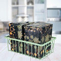 GoHooked green metal wire grid basket holding two wrapped gifts with snowflake and ornament design.