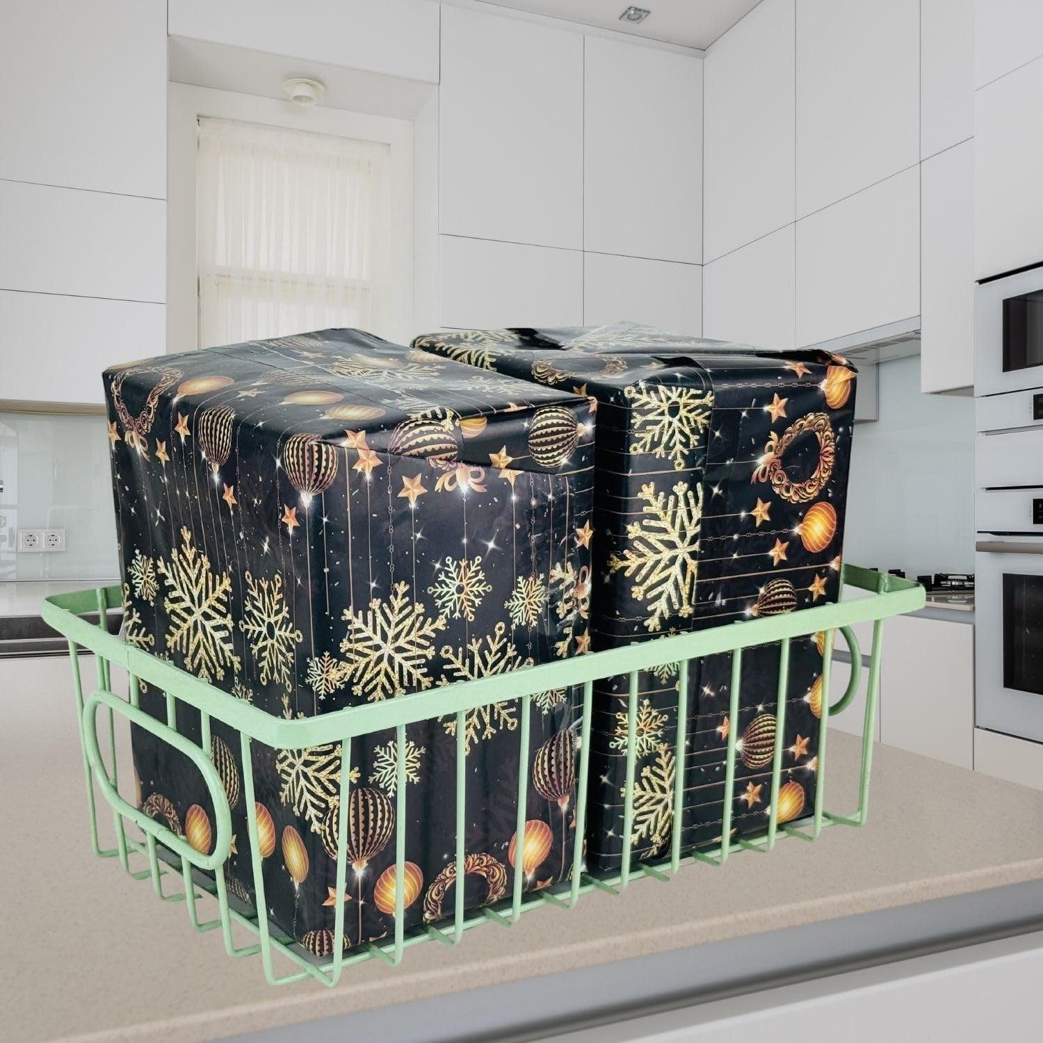 GoHooked green metal wire basket with handles holding two large gifts wrapped in black paper with gold snowflakes and ornaments.