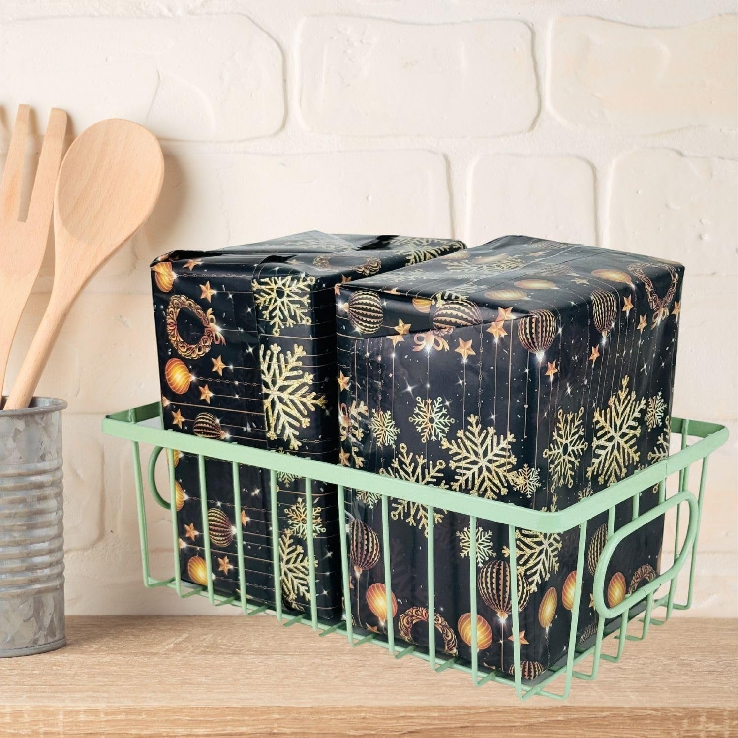 GoHooked green metal wire grid basket holding two wrapped gifts with snowflake and ornament pattern