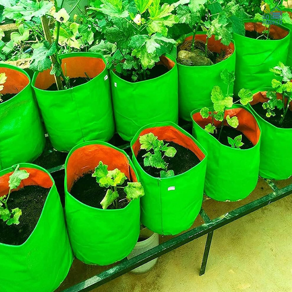 GoHooked green and orange heavy-duty fabric grow bags filled with soil and small plants on a balcony garden rack