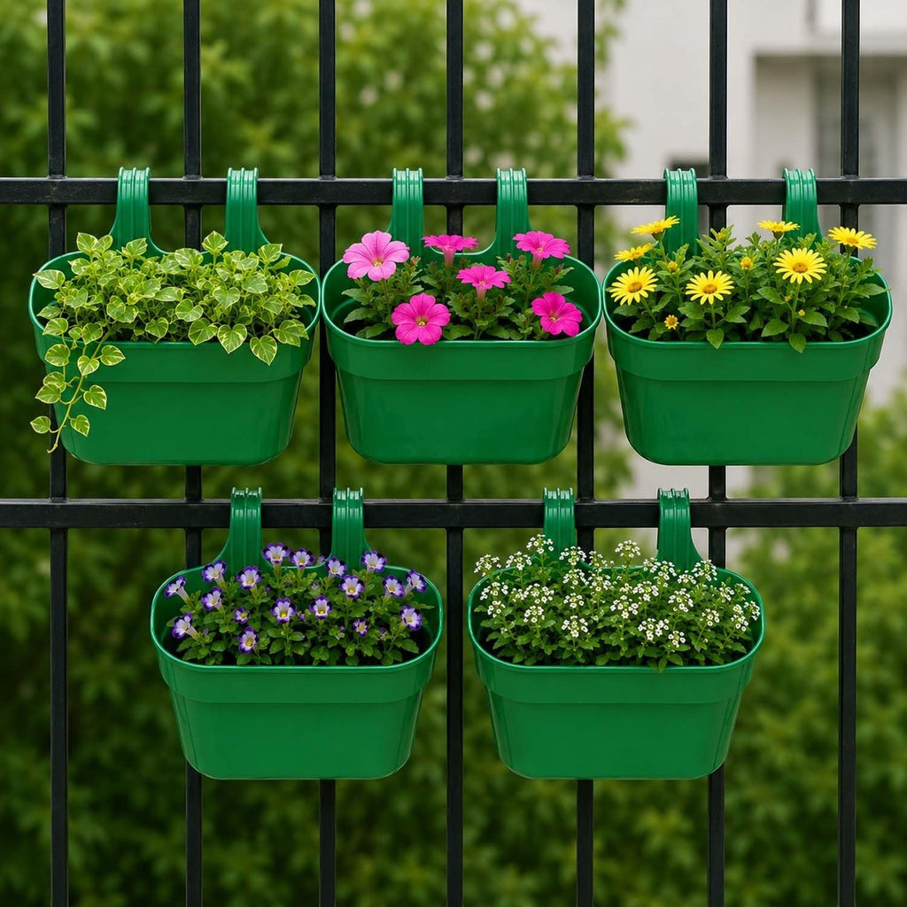 GoHooked green plastic railing hanging planter pots with double hooks, holding various flowers and plants on a black fence.