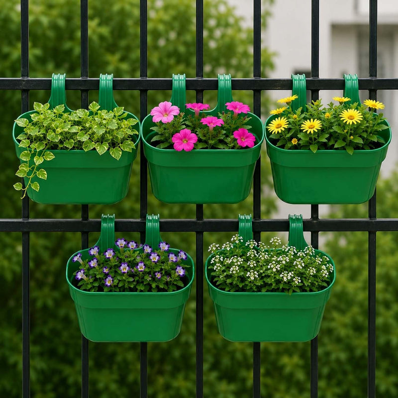 GoHooked green plastic railing hanging planter set of 5, rectangular pots with double hooks holding flowers and plants on a black fence.