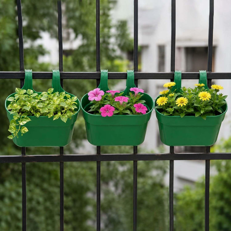 GoHooked set of 3 green plastic railing hanging planters with double hooks, holding green foliage, pink petunias, and yellow daisies.