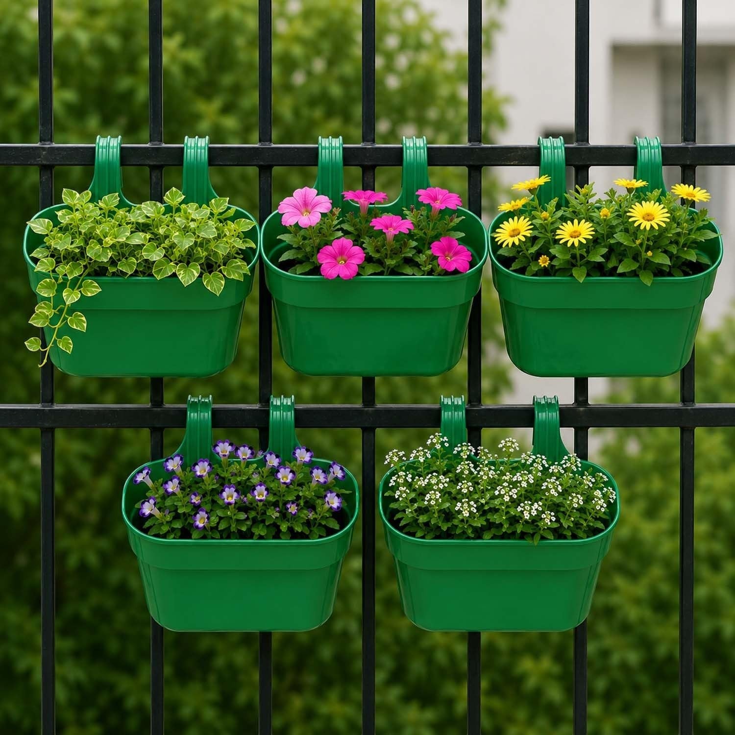GoHooked set of 5 green plastic railing planters with double hooks, holding various flowers and plants on a black fence.