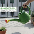 Go Hooked green 1.8L plastic watering can with yellow spout and red shower head, watering a succulent.