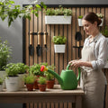 GoHooked green plastic watering can with yellow and red sprayer, 1.8L capacity, for indoor and outdoor plants.