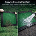 GoHooked green rubber door mat with footprint design being cleaned with water and shaken to remove dirt.