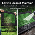 GoHooked green rubber door mat with a decorative black border and ribbed surface being cleaned outdoors.