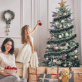 GoHooked Set of 3 green and white tinsel garlands for Christmas tree decoration. A mother and daughter decorate the tree.