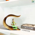 Go Hooked green polyresin meditating woman yoga statue with hands in prayer pose, seated on a gold leaf-shaped base.