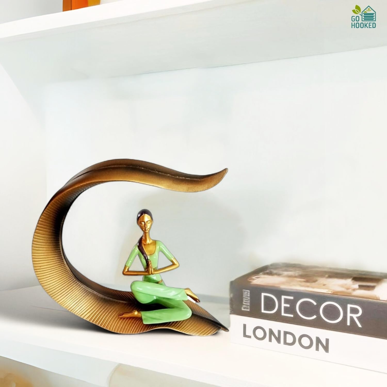 Go Hooked green polyresin meditating woman yoga statue with hands in prayer pose, seated on a gold leaf-shaped base.