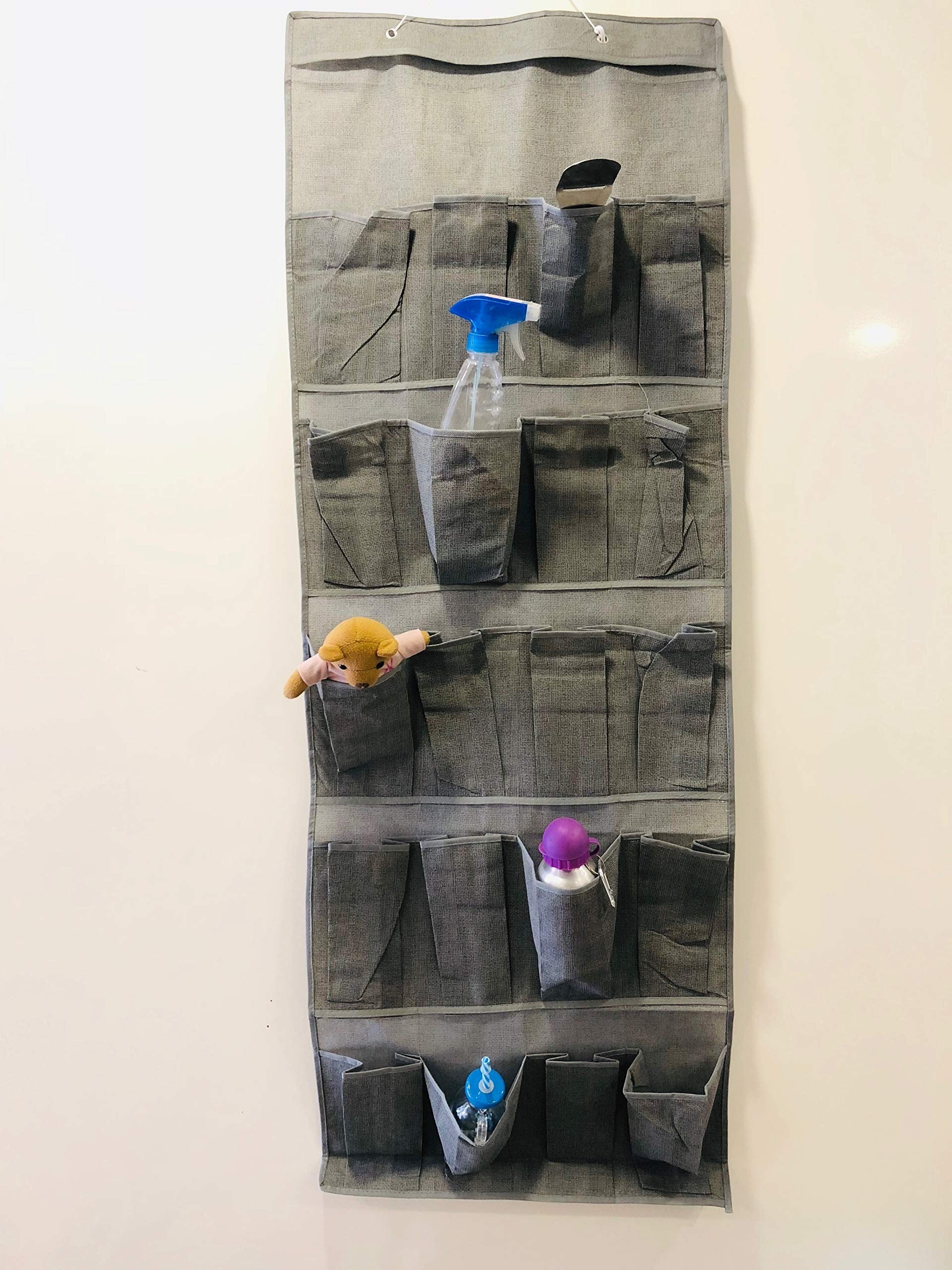 GoHooked grey fabric 20-pocket over-the-door organizer with clear pockets holding various items like a spray bottle and toys.