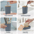 GoHooked grey ribbed bathroom accessories set: soap dispenser, toothbrush holder, tumbler, and soap dish. Modern design.
