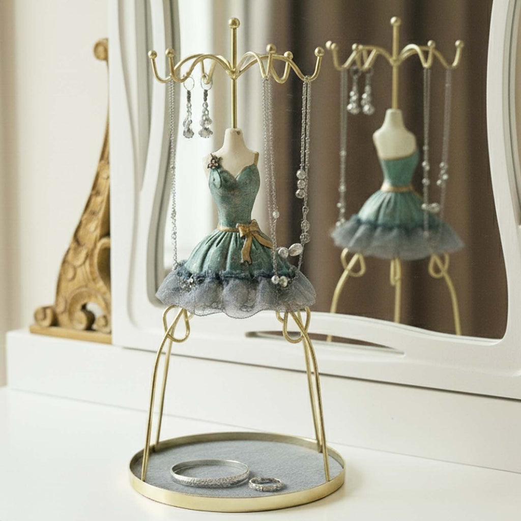 GoHooked grey doll dress jewelry holder stand with metal hooks and a velvet-lined base tray on a vanity table