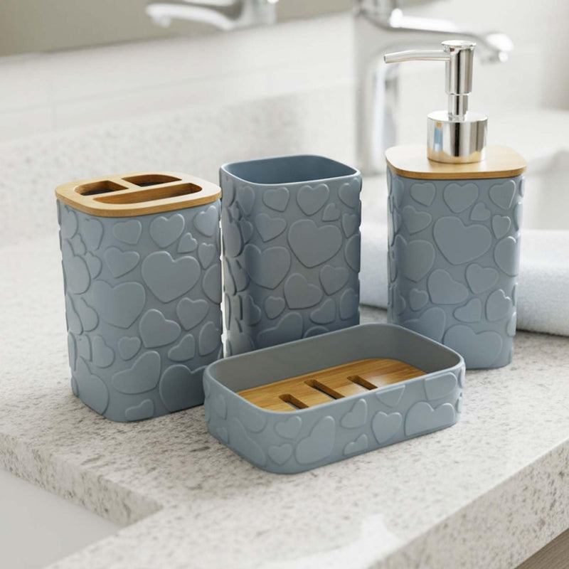 Go Hooked grey bathroom accessory set with heart texture, includes soap dispenser, tumbler, toothbrush holder, and soap dish with bamboo accents.