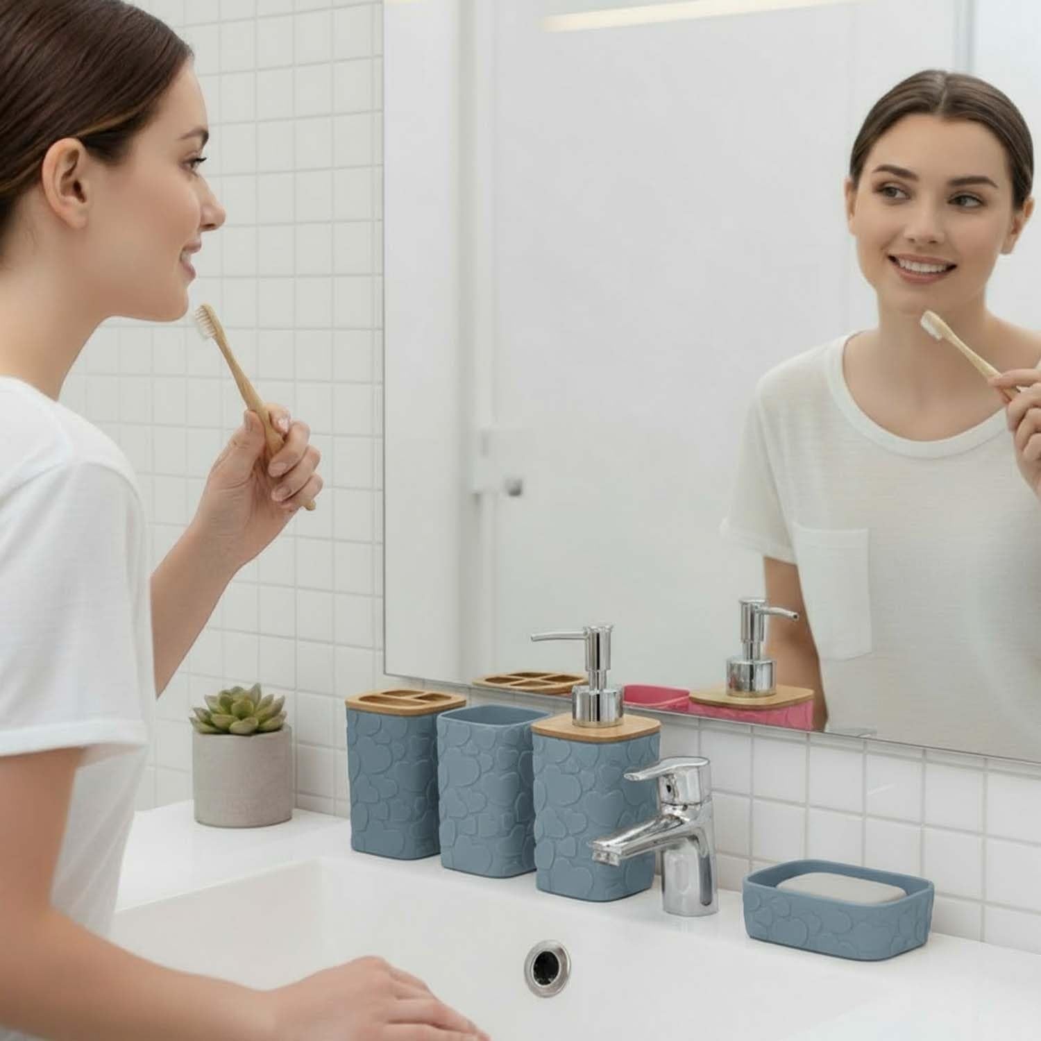 Go Hooked grey plastic bathroom accessory set with heart embossed design, includes soap dispenser, toothbrush holder, tumbler, and soap dish.