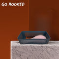 Go Hooked grey plastic storage basket with integrated handles, holding a pink hairbrush and a wooden comb.