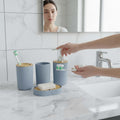 Go Hooked grey ribbed plastic bathroom accessories set with soap dispenser, tumbler, toothbrush holder, and soap dish.