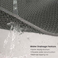 GoHooked grey rubber anti-skid bathroom mat with honeycomb drainage structure, water flowing through.