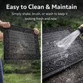 GoHooked grey heavy-duty rubber door mat with ribbed surface and decorative border being cleaned with water