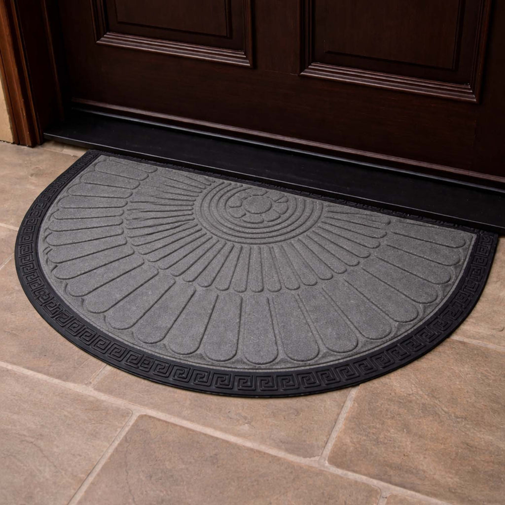 GoHooked semi-circle rubber door mat in grey with a black border and sunburst pattern on a tiled floor.