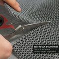 GoHooked grey anti-skid rubber bathroom mat being trimmed with scissors for a custom fit in wet areas.