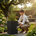 GoHooked grey tall square polymer planter with ribbed texture, 30 inches, holding a snake plant in a garden.