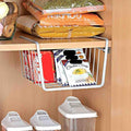 GoHooked grey mild steel undershelf basket holding packets of chicken soup and candy bars.
