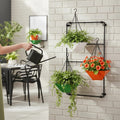 Go Hooked multicolor 9-inch hanging planters set of 3, made of virgin plastic and iron, on a wall rack.