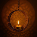 GoHooked matte gold metal round hanging tealight candle holder with floral cut design and chain.
