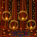 Set of 4 GoHooked matte gold metal hanging tealight candle holders with floral cut design and chains.