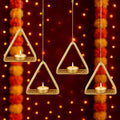 GoHooked set of 4 matte gold metal hanging triangle tealight candle holders with floral cut design and chain.