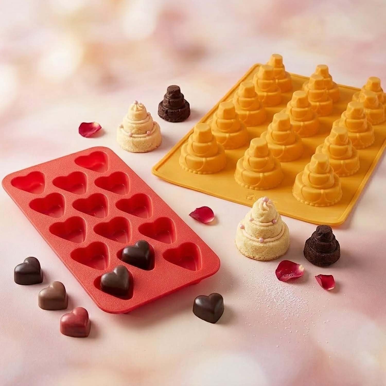 GoHooked red heart-shaped silicone chocolate mold with 11 cavities and a yellow tiered cake mold on a pink background.