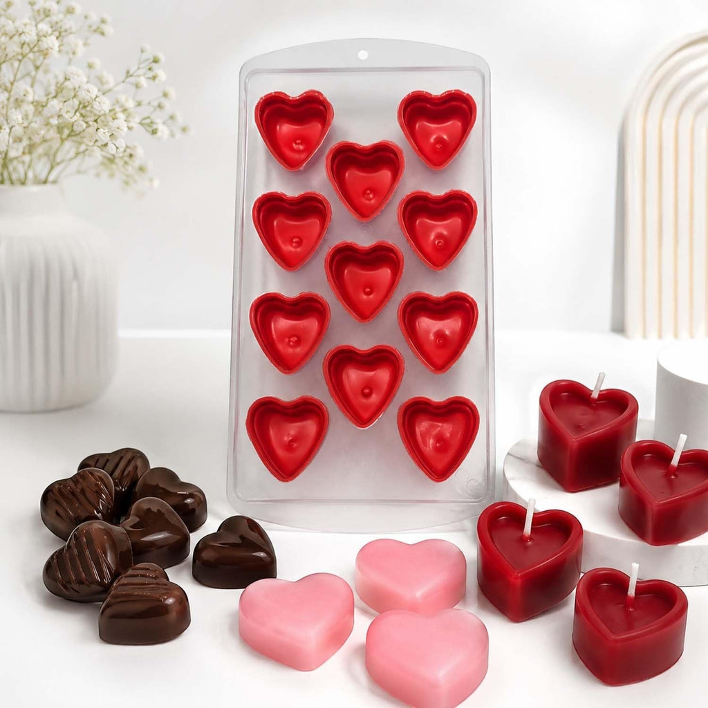 GoHooked 11-cavity red silicone heart-shaped mold for chocolates, candles, and homemade treats on a white table.