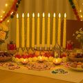 Go Hooked Set of 3 ivory LED taper candles, 26.7cm tall, with flickering flames, on a decorated table.