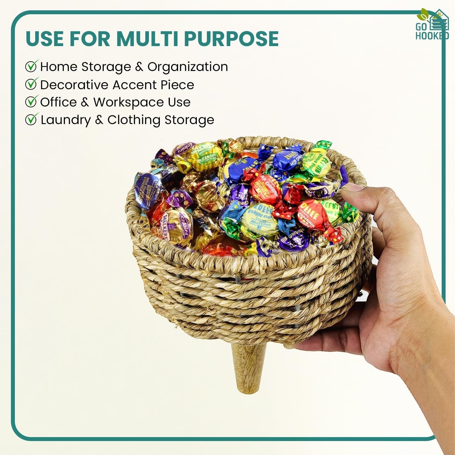 GoHooked brown woven jute basket with wooden legs, filled with assorted candies. Ideal for storage or decor.