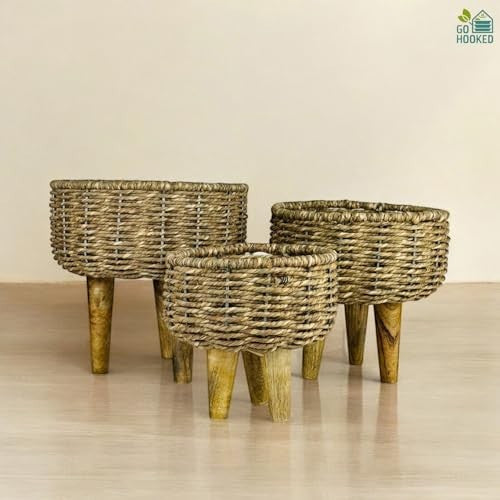 Go Hooked set of 3 brown woven jute plant stands with wooden legs. Handmade boho decor baskets for indoor plants.