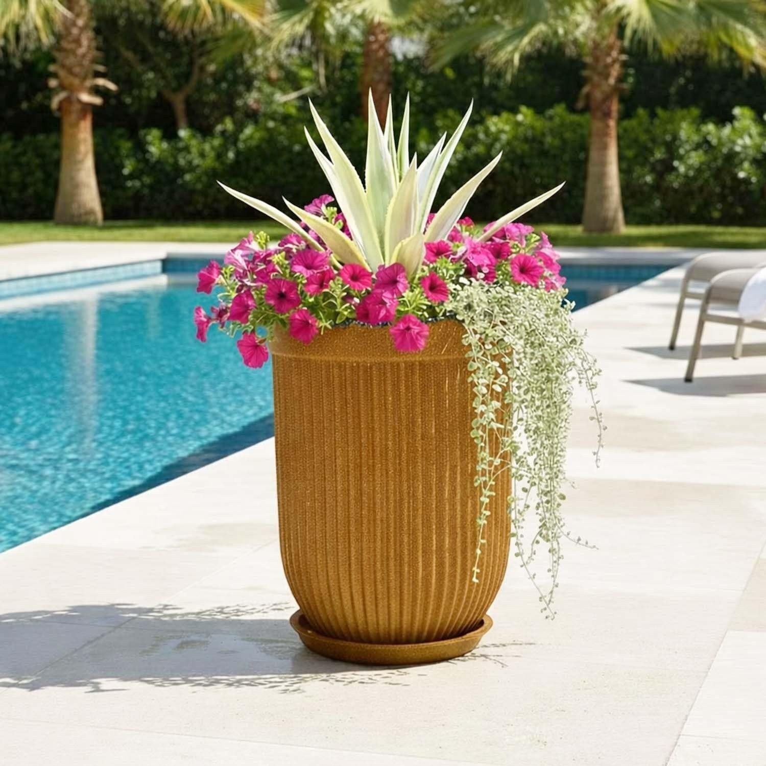 GoHooked large ribbed polymer planter in a warm brown color with a matching saucer, holding pink petunias and an agave plant.