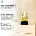 GoHooked gold and white polyresin Laughing Buddha statue, symbol of wealth and happiness, on a black base.