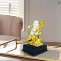GoHooked white and gold polyresin laughing Buddha statue symbolizing prosperity and happiness, on a black base.