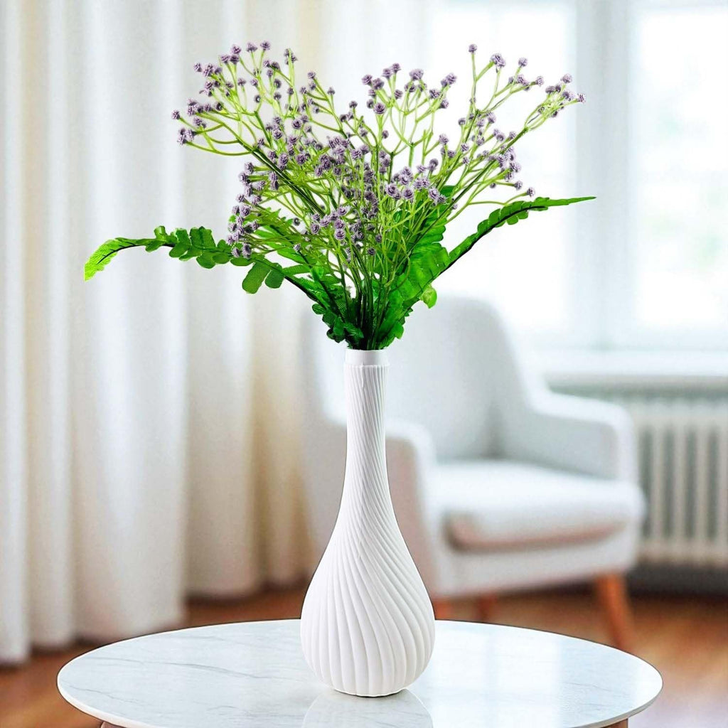 Go Hooked lavender baby's breath artificial flowers with green fern leaves in a white swirl vase.