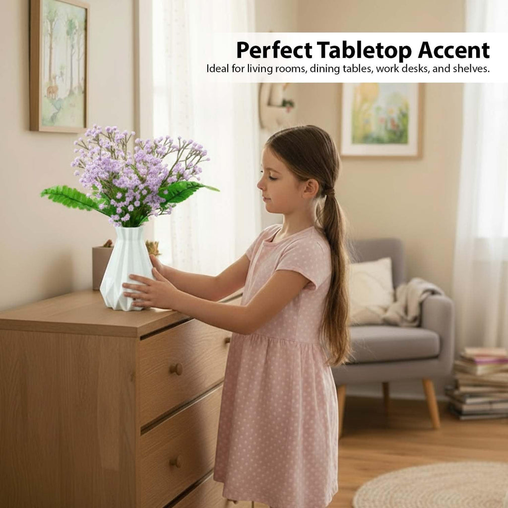Go Hooked lavender baby's breath artificial flowers with green fern leaves in a white vase on a dresser.