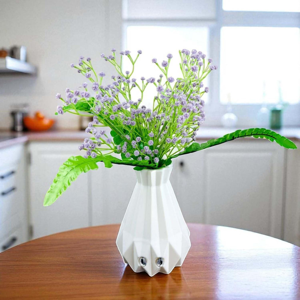 Go Hooked lavender baby's breath artificial flowers in a white geometric vase with fern leaves. Realistic faux plant decor.