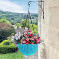 GoHooked light blue plastic hanging pot with woven texture, filled with colorful flowers. 7.1 inch diameter.