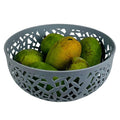 GoHooked light grey plastic fruit bowl with decorative cutouts, holding green and yellow mangoes.
