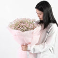 GoHooked light pink artificial baby's breath flowers in a bouquet with a vase, featuring realistic rubber flower heads and flexible stems.