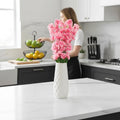 Go Hooked light pink artificial flowers in a textured white ceramic vase, perfect for home or office decor.