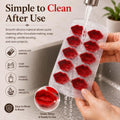 GoHooked silicone chocolate mold with 10 lip-shaped cavities being rinsed under a kitchen faucet