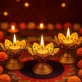 GoHooked matte gold lotus tealight holders, set of 3, with lit tealights. Metal candle holders for festive decor.